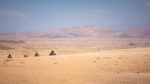 Group of quad bikers exploring the vast Agafay desert near Marrakech, Morocco.
