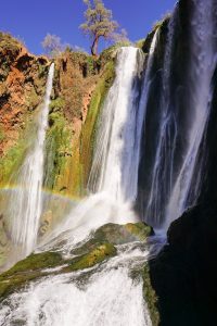 waterfalls on brown rocky mountain during daytime